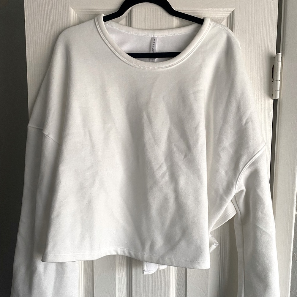 White Fabletics crew neck criss-cross tied back sweatshirt. Size L